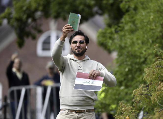 Activist Salwan Momika outside the Iraqi embassy in Stockholm with an Iraqi flag and a copy of the Koran in his hands, July 20, 2023.