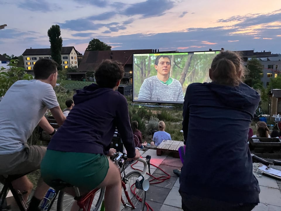 Cinema viewers pedal and look at the screen