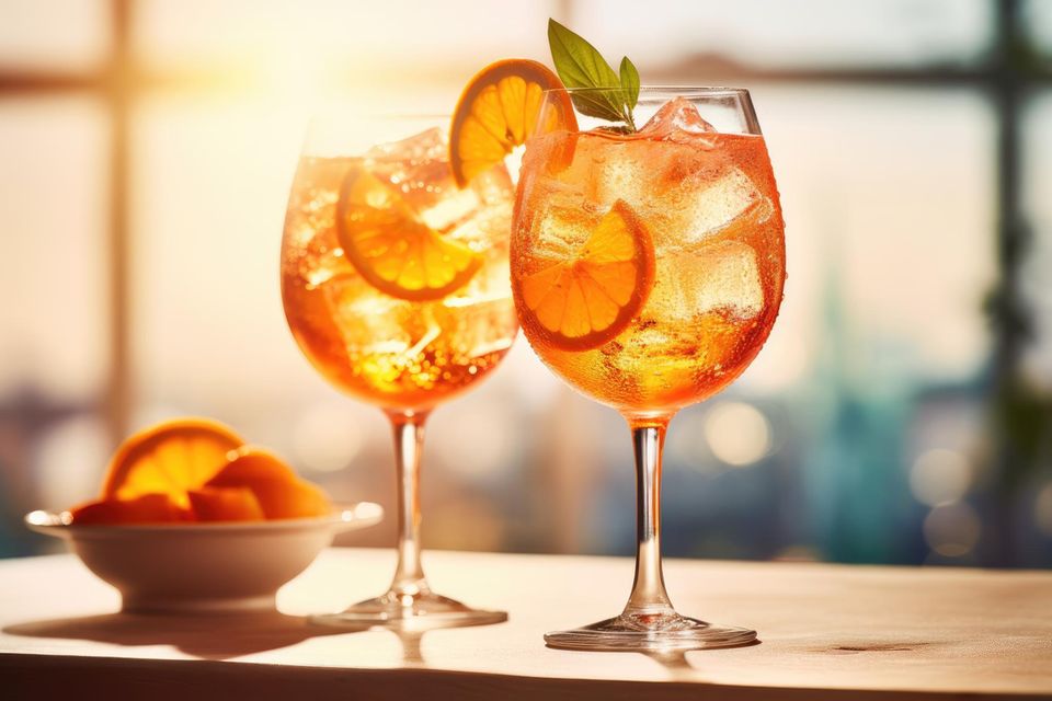 Two glasses of Aperol Spritz against the light