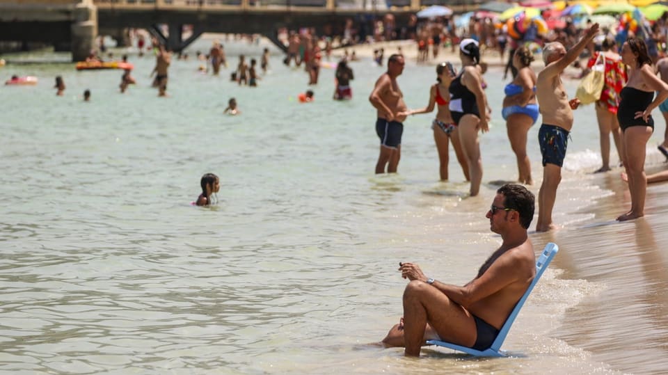 People cool off on Mondello beach in Palermo.