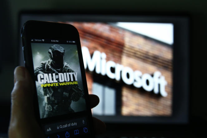 An image of Activision Blizzard's 'Call of Duty' is shown on a smartphone near a photograph of the Microsoft logo, in this photo taken in New York, Thursday, June 15, 2023. 