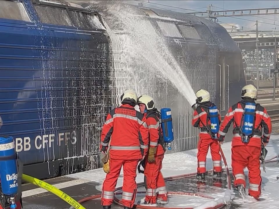 Firefighters extinguish the locomotive.
