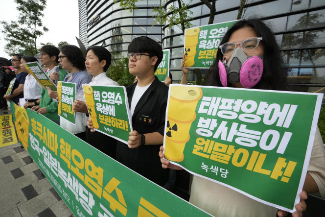 Protest against the Japanese government's decision to discharge sewage from Fukushima, near a building housing the Japanese embassy in Seoul, June 30, 2023. Signs read 'Radioactive water in underground facilities'.
