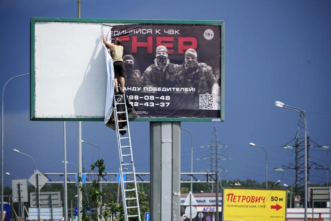 Removal of a Wagner Militia recruiting poster near St. Petersburg on June 24, 2023.