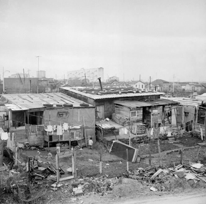 The shantytown of Nanterre, where a large number of Algerian immigrant families lived, on March 24, 1964. In the background, the large housing estates.