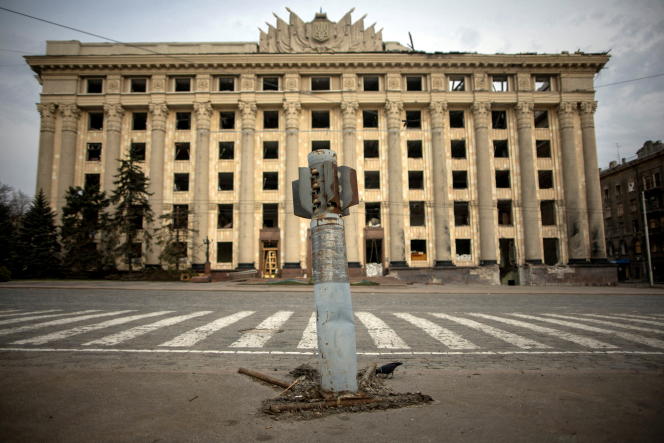 An installation depicting a Russian missile driven into the ground, in front of the damaged regional state administration building in Kharkiv, Ukraine, on April 11, 2022.