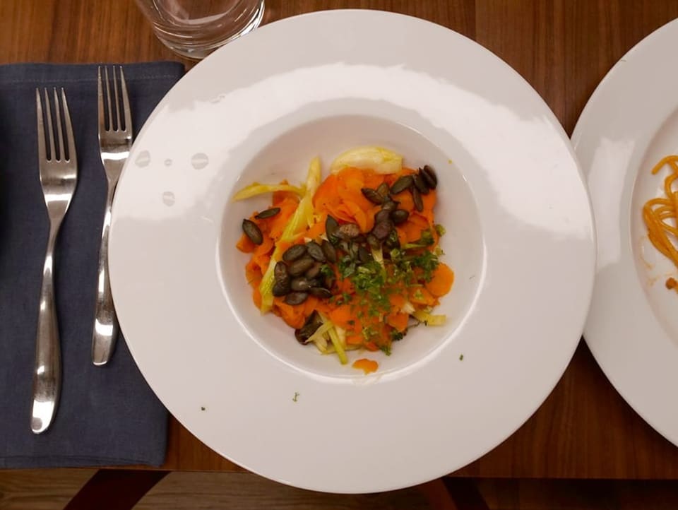 Plate with boiled vegetables and pine nuts