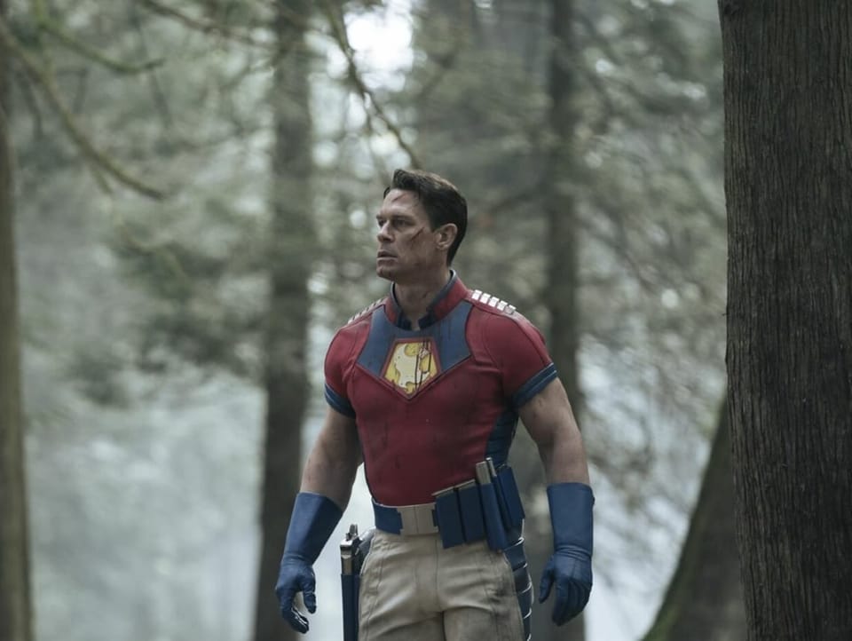 Muscular superhero stands in winter forest