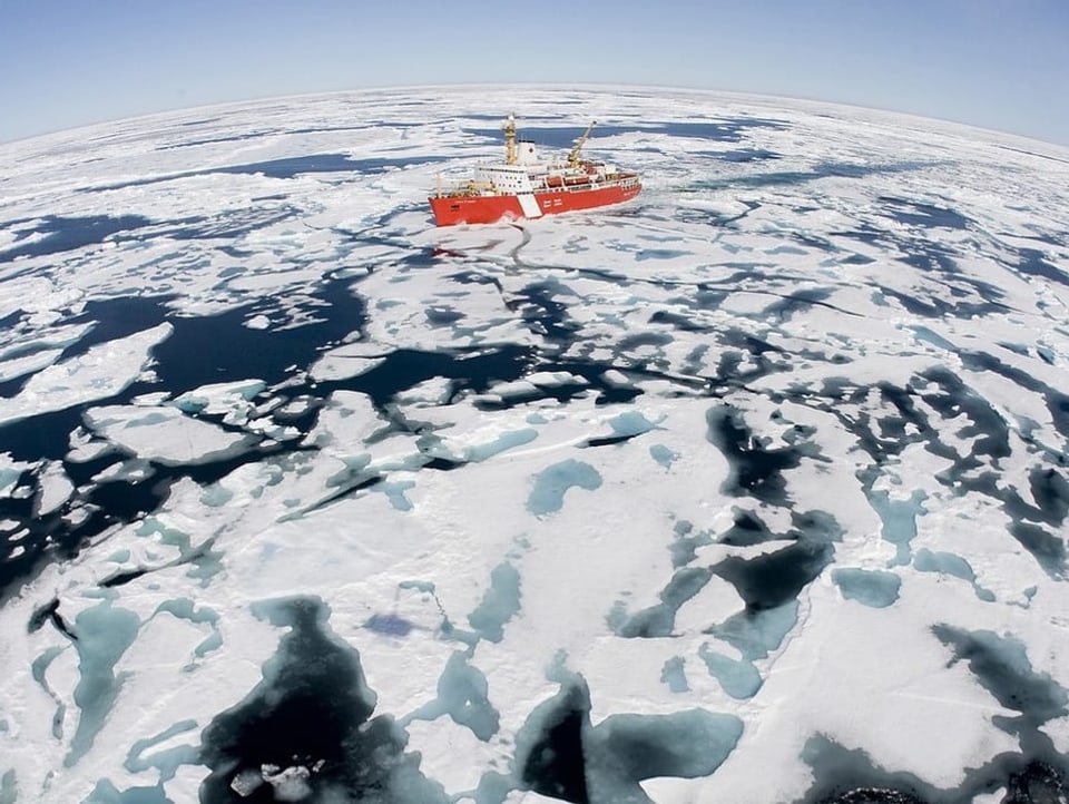 The Northeast Passage in the Arctic.  A freighter sails on the water. 