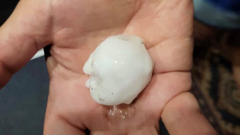 A large hailstone in one hand.