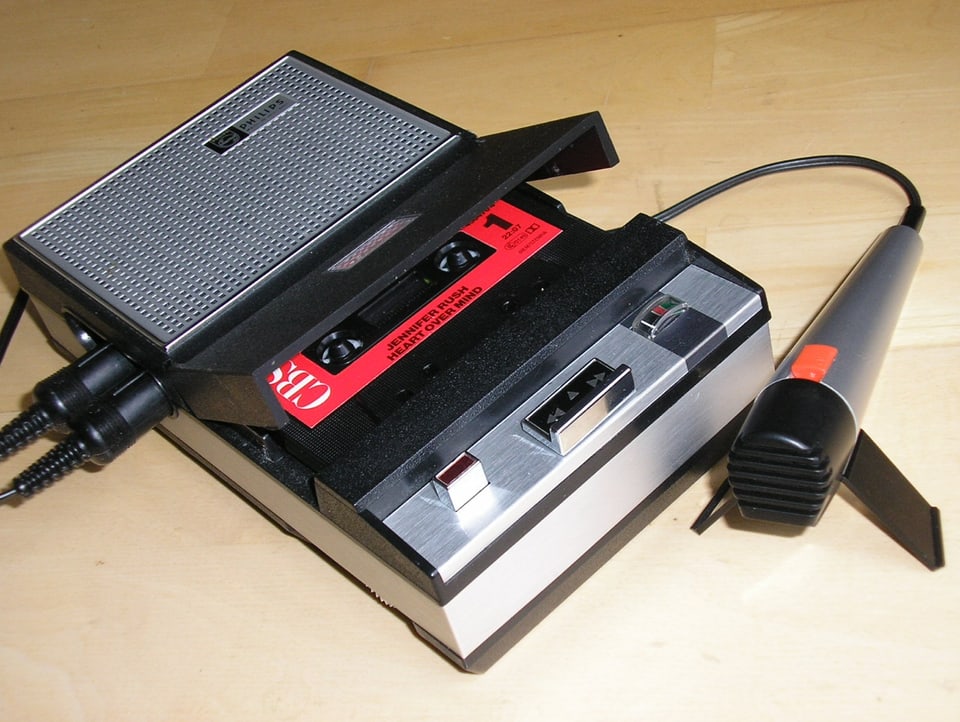 An old cassette recorder with a microphone on the table