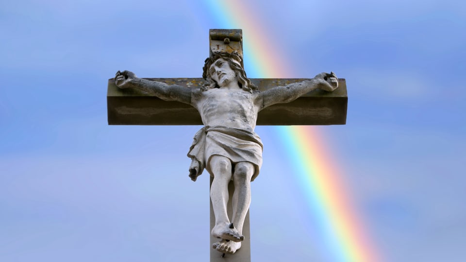 Jesus on the cross, behind a rainbow.