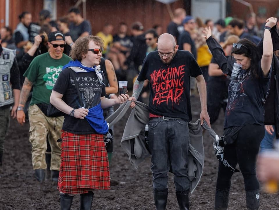 Concert-goers wade through the mud 