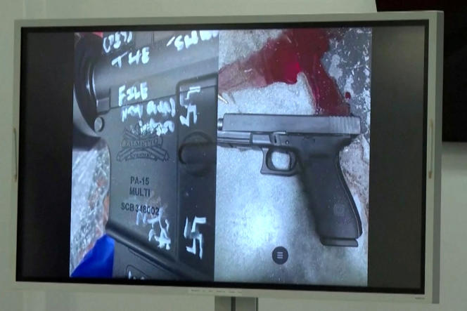Photographs shown at a press conference of the swastika-covered rifle and pistol of the shooter who killed three black people in Jacksonville, Florida, August 26, 2023.