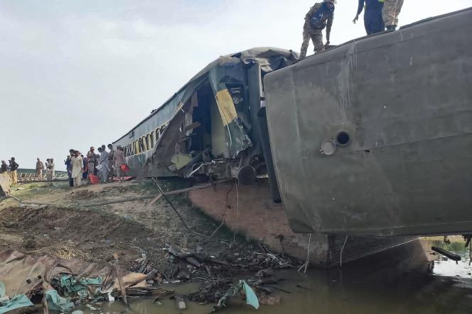 Paramilitary officers inspect carriages at the crash site, after a passenger train derailed, in Nawabshah, southern Pakistan, August 6, 2023.