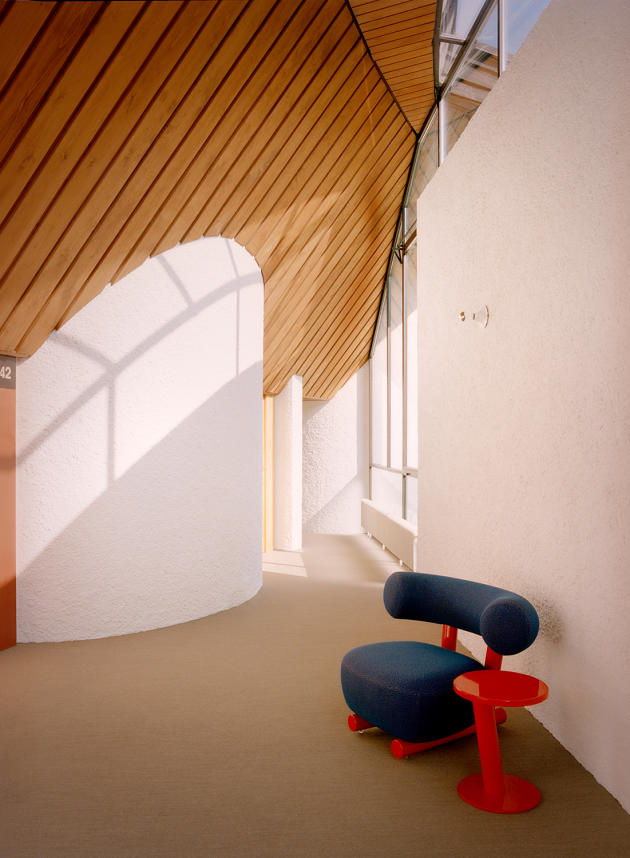 In a passageway, Pipe armchair and side table, design Sebastian Herkner for the Italian furniture designer Moroso.