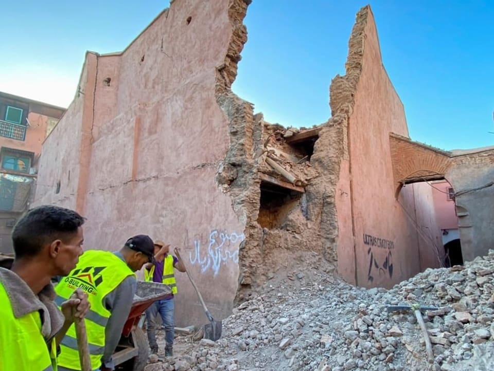 Relief workers clear away rubble from a destroyed building in Marrakesh.