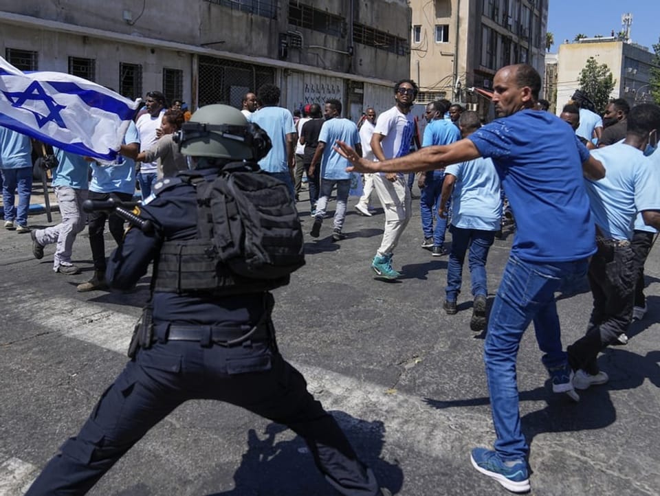 Eritrean demonstrators and Israeli riot police clash in Tel Aviv. 