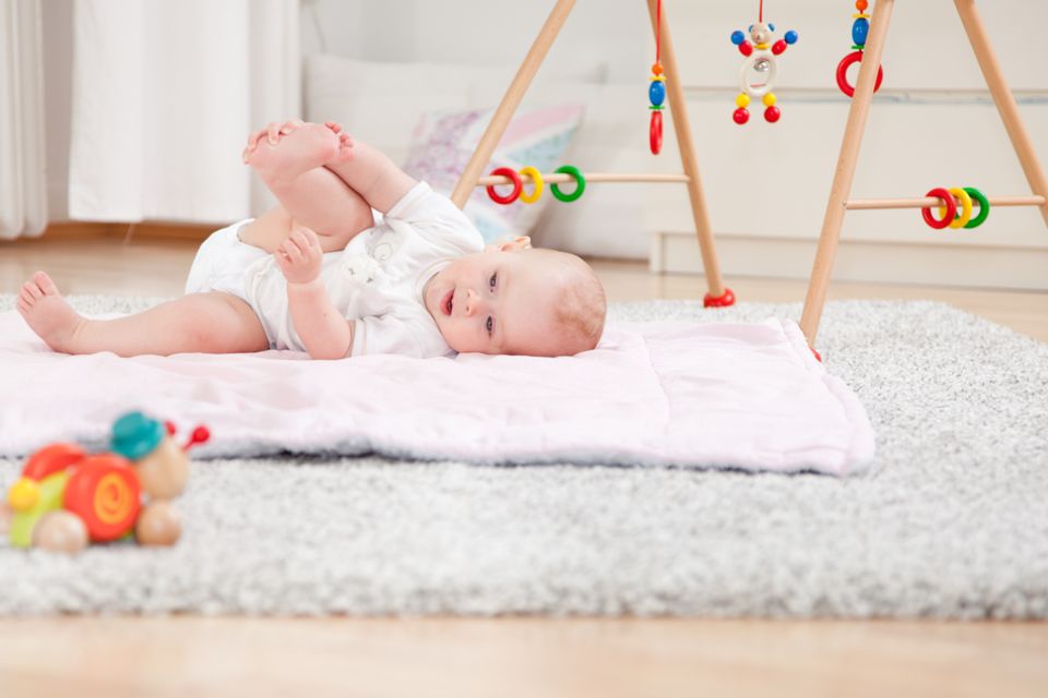 Set up baby room: baby on a blanket on the floor