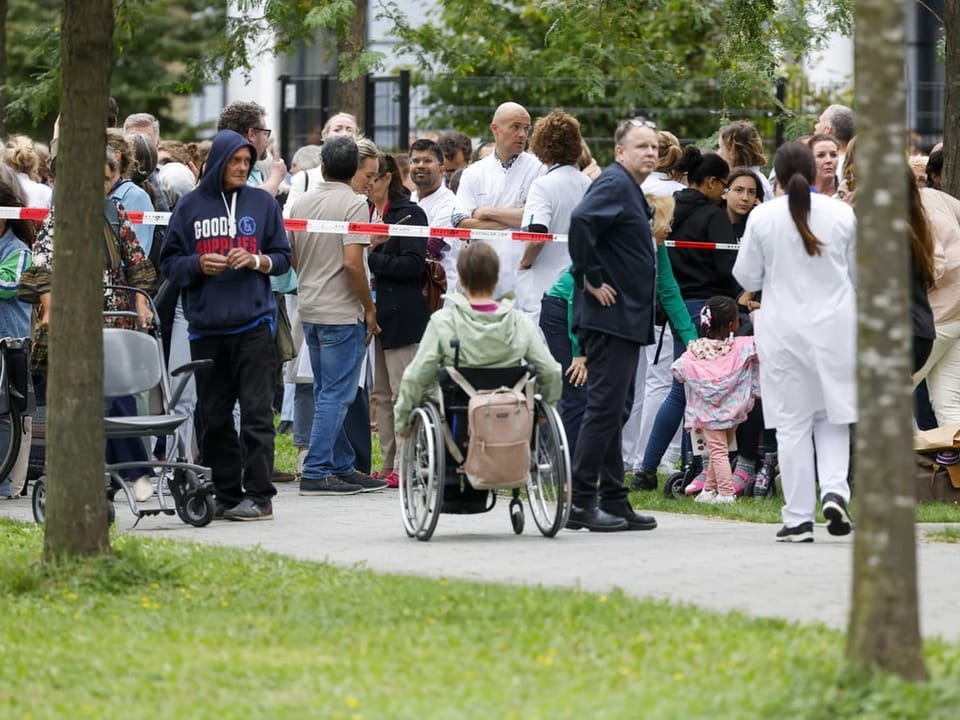 Hospital staff and patients wait outside the hospital in Rotterdam.
