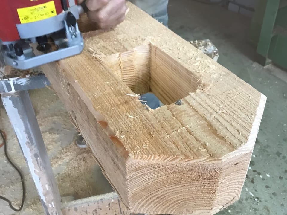 Piece of wood is clamped into a punching machine.