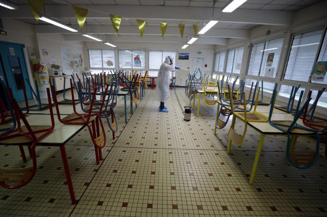 A disinfection team cleans the school canteen at the Saint-Exupéry primary school in Cannes, France, on May 5, 2020.