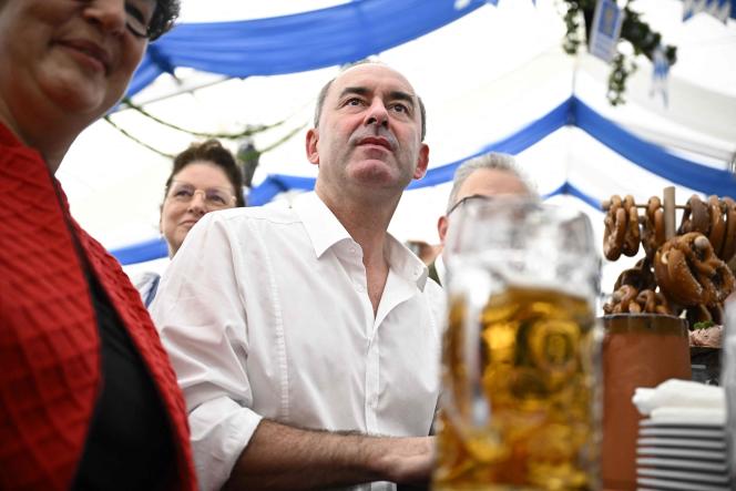 Bavarian State Deputy Prime Minister Hubert Aiwanger sits next to spectators in a beer tent, in Keferloh, in the municipality of Grasbrunn, near Munich, on September 3, 2023, during a rally of campaign for the next elections.
