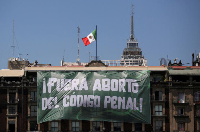 A banner reading “Abortion outside the penal code” hangs from a building in Zocalo Square in Mexico City, March 8, 2023.