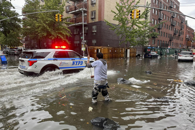 In the Brooklyn neighborhood, a man tries to clean a pipe, in New York, September 29, 2023.