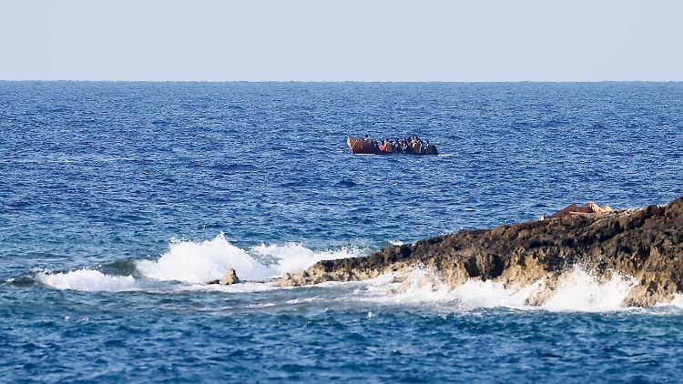Migrants arrive in a boat on the Mediterranean island of Lampedusa in mid-September.