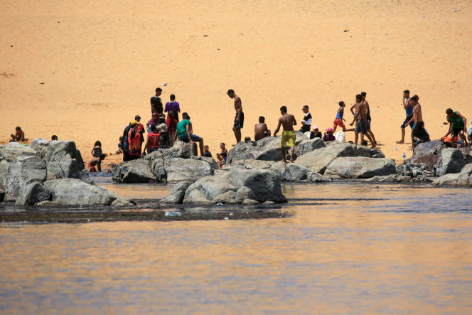 Sudanese refugees relax on the banks of the Nile in Aswan on September 8, 2023.