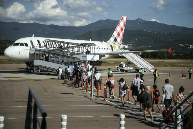 Travelers board a Volotea flight at Napoleon Bonaparte airport in Ajaccio, July 14, 2020.