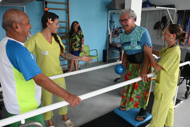 Alfred Mahotu (left) and Justin Teautouahaavao (right) practice balance exercises with their physiotherapists at the Te Tiare rehabilitation center in Tahiti, French Polynesia, July 26, 2023.
