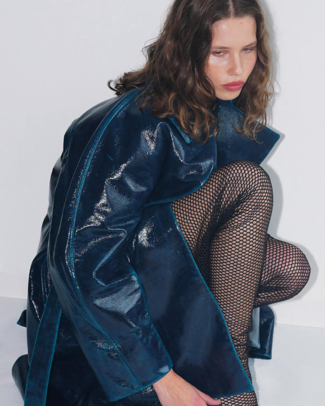 Mirror-effect wool trench coat, €3,600, and fishnet thigh-high boots, Alaïa.  house-alaia.com