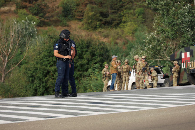Kosovar police officers, American soldiers and members of KFOR, near the scene where a Kosovar police officer was killed, Sunday September 24, 2023.