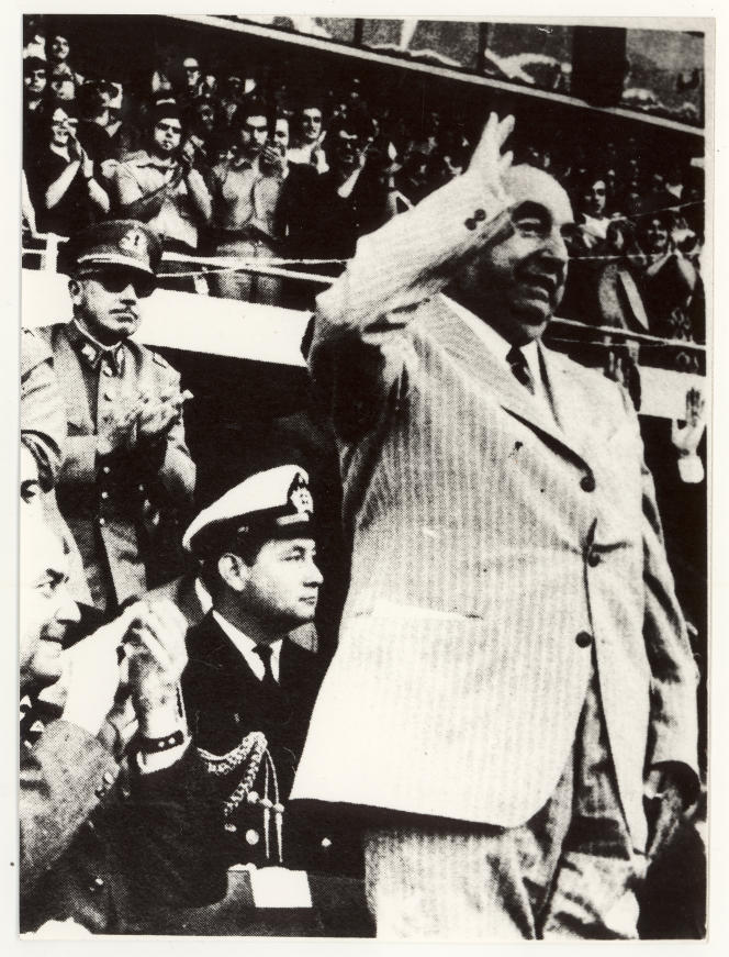 Pablo Neruda (in the foreground) and Augusto Pinochet (black glasses, on the left), on December 5, 1971, in the national stadium of Santiago, Chile, during a ceremony in honor of the Nobel Prize.  Photo taken from “Residing on the Earth”.