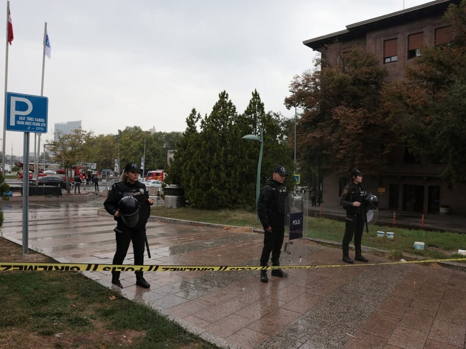Police officers stand guard near the Interior Ministry after the bombing in Ankara. 