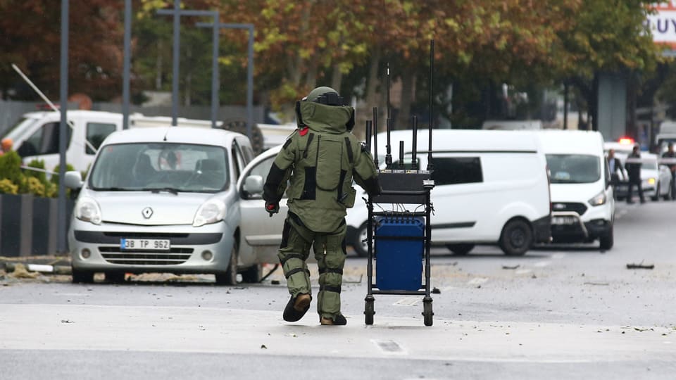 A bomb disposal officer works at the crime scene in Ankara.
