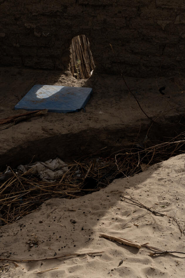 Mohamat Kollé Ali, 21, opened a breach in the surrounding wall of the family home to allow water to drain, following the floods of July and August 2022. In Baga Sola, in shore of Lake Chad, April 1, 2023.