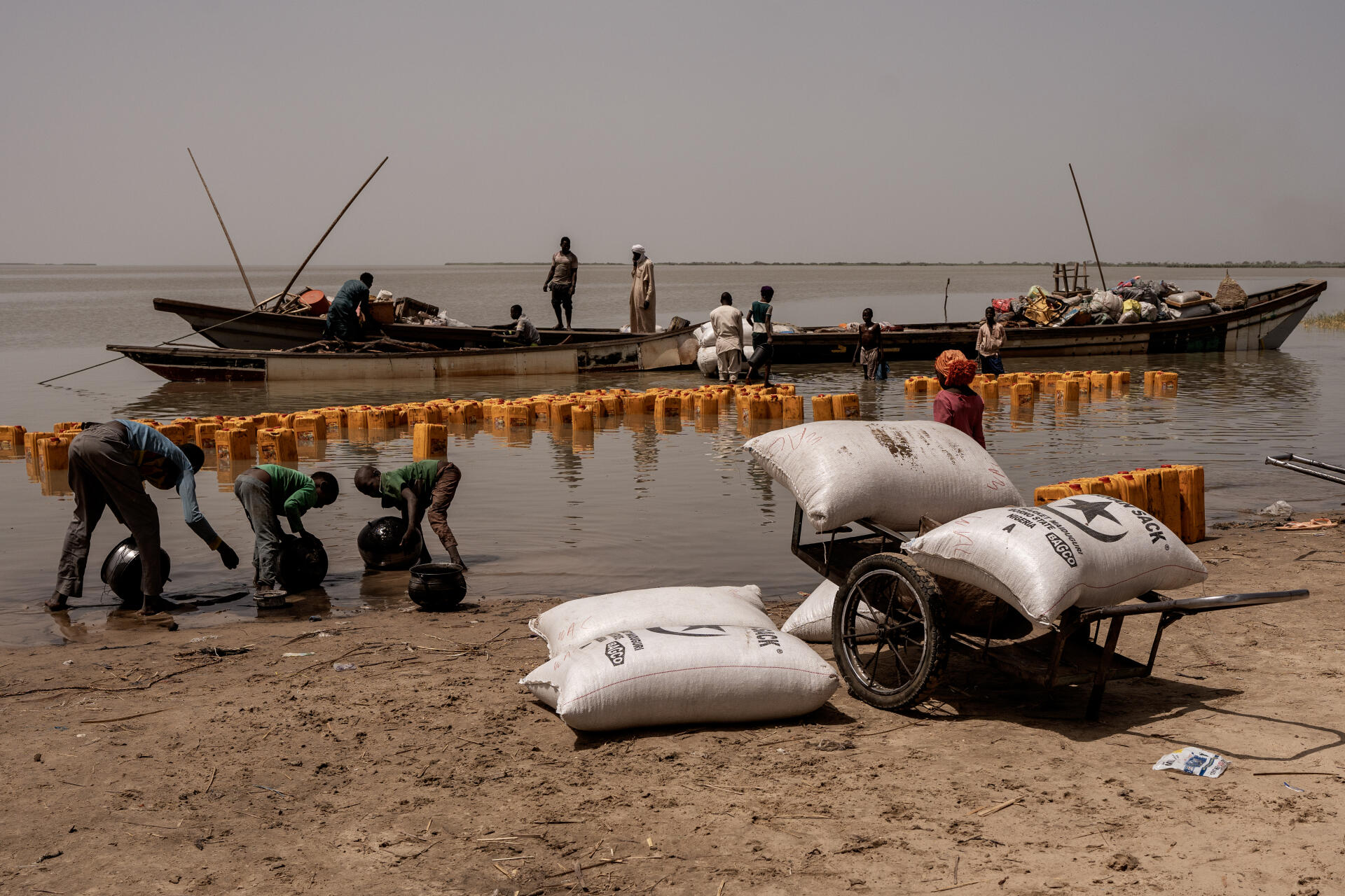 People unload a commercial boat on Koulfoua Island on Lake Chad, Chad, April 3, 2023.
