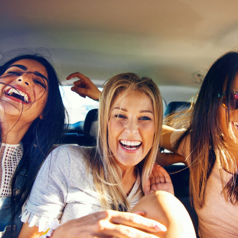 Finding joy in life again: three women laughing in the car