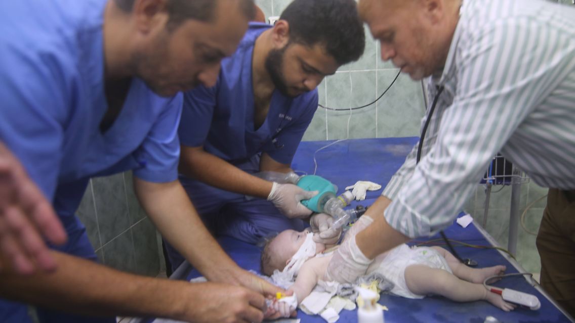 A medical team at a hospital in Rafah, southern Gaza, cares for an injured infant.