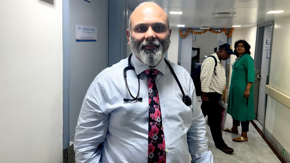 Portrait of Dr.  Lancelot Pinto, pulmonologist at Hinduja Hospital in Mumbai, in a hospital corridor.