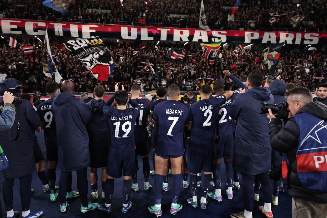 PSG players celebrate with supporters their victory against AC Milan, on October 25, 2023, at the Parc des Princes, in the group stage of the Champions League.