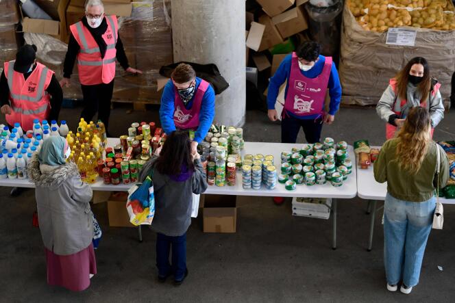 Volunteers from Restos du coeur distribute food and products to students, at the Stade-Vélodrome in Marseille, southern France, March 26, 2021.