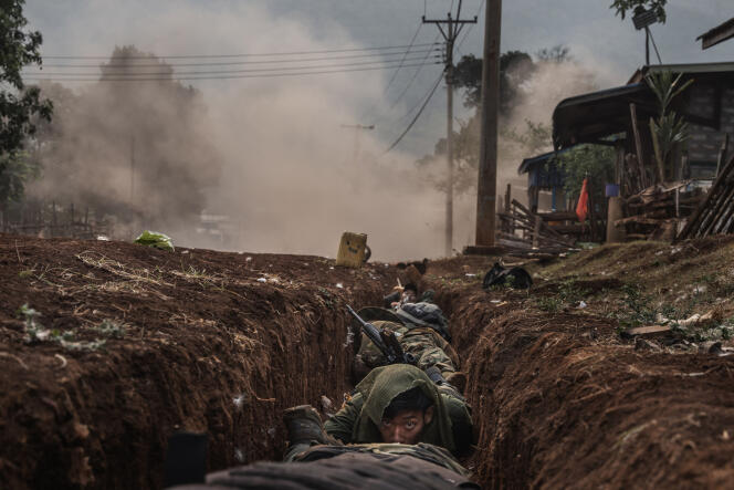 Karenni soldiers take shelter in a drainage ditch as a mortar shell explodes nearby during violent clashes on April 16, 2023, in Daw Nyay Khu village in Kayah (Karenni) State, east of Burma.  This photo received the first Bayeux Prize for War Correspondents 2023.