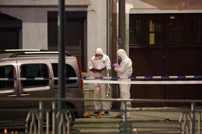 Belgian police officers from the forensic service search a street for evidence after two people were killed in a gun attack in Brussels on October 16, 2023.