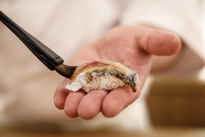 Preparation of sea bream sushi, called “Tai no nigiri”, by Tomoyuki Yoshinaga, chef of the Sushi Yoshinaga restaurant in Paris.