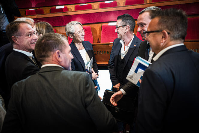 Labor Minister Olivier Dussopt (right) chats with union officials and Prime Minister Elisabeth Borne, during the social conference at the Economic, Social and Environmental Council, in Paris, France on October 16, 2023.