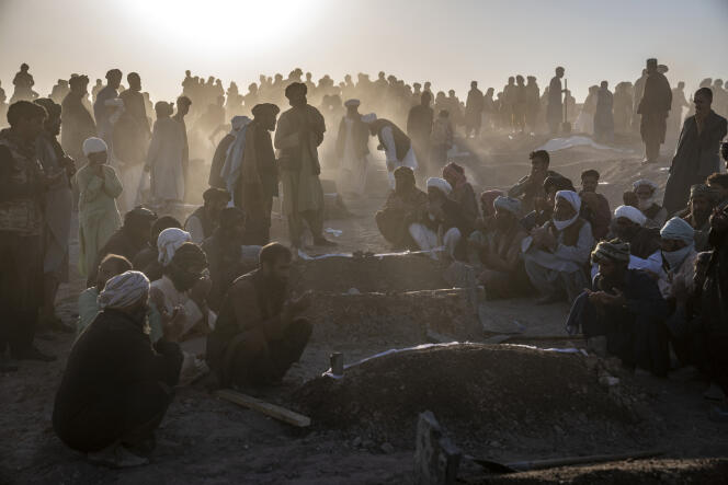 Hundreds of bodies were buried after the earthquake in a village in Zendeh Jan district on October 9.